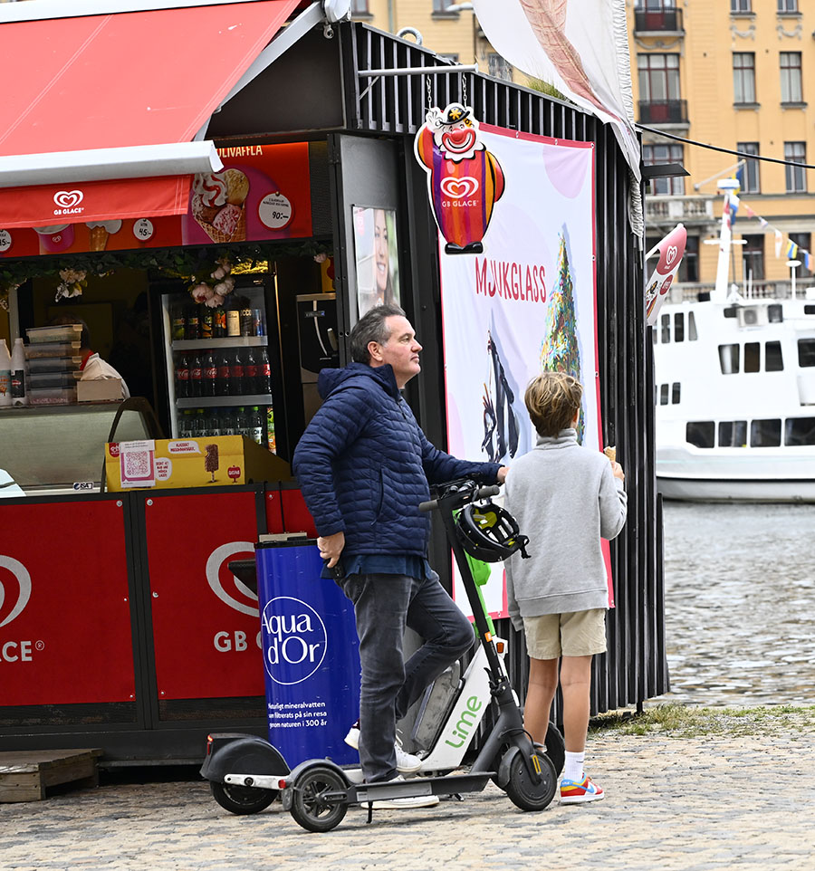 Chris O'Neills nya sportiga stil – åker elsparkcykel i Stockholm